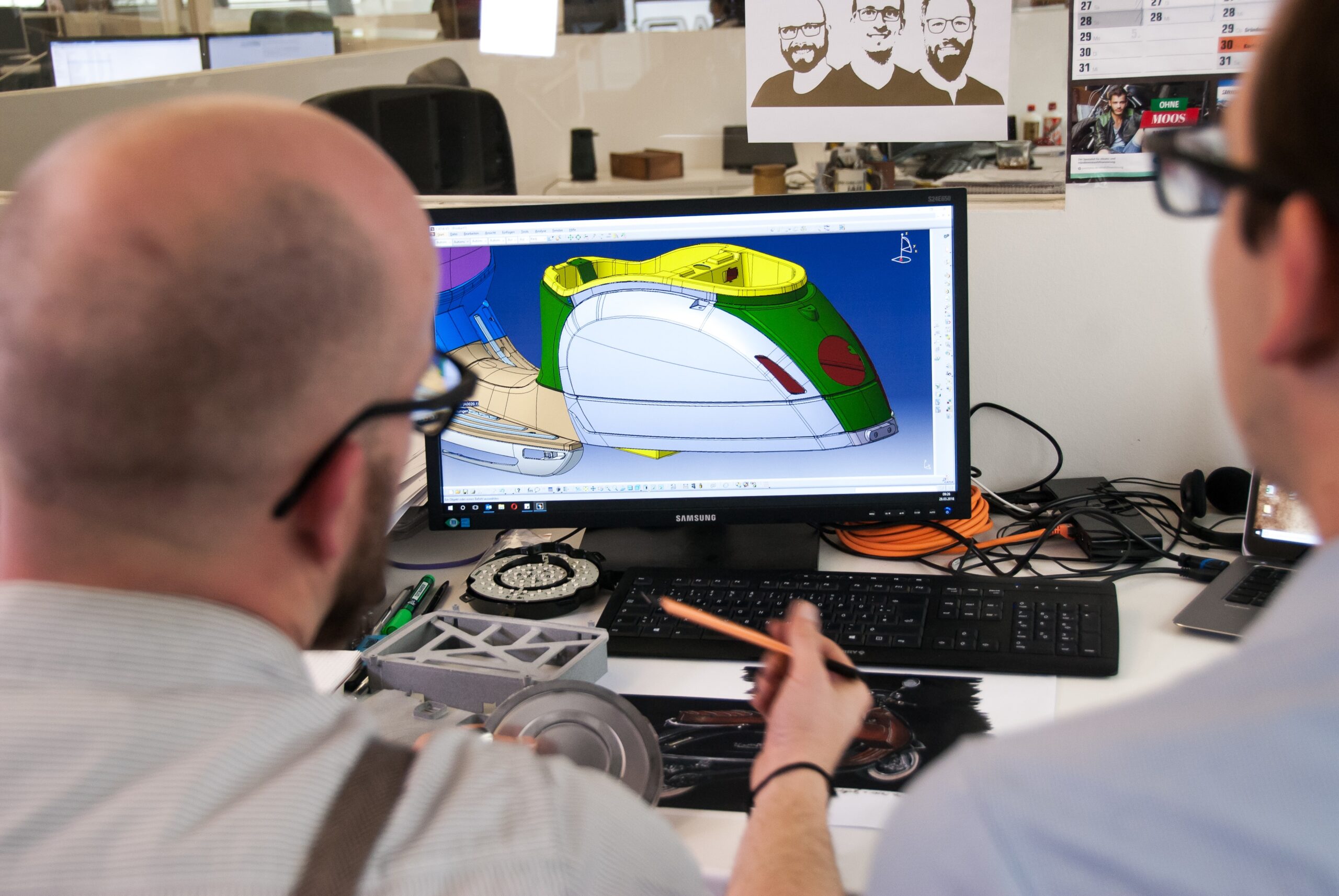 two people looking at a CAD software
